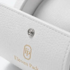 White leather watch box detail showing grain, stitching, snap and gold branding