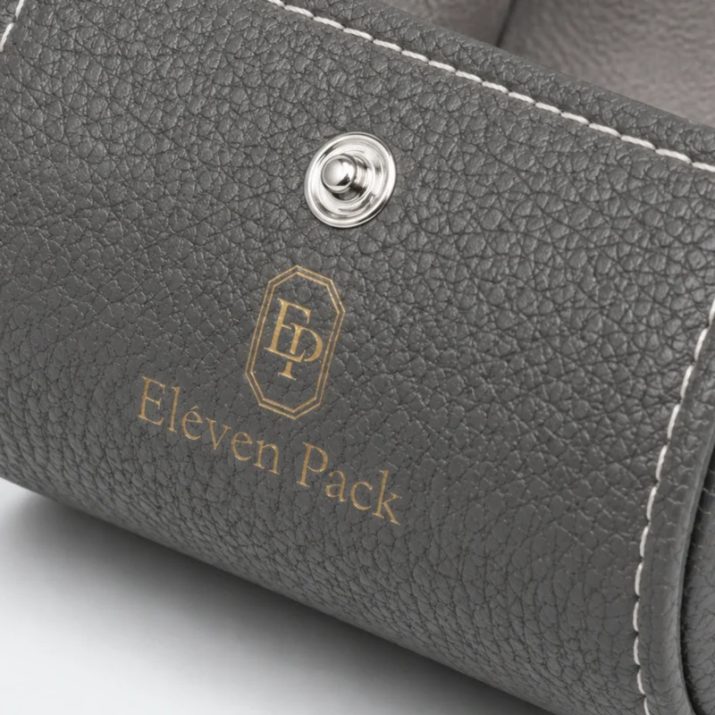 Custom Gray Leather Vintage Watch Box Image 04 Material Brand Detail - JB-BM-03-P20 Close-up of gray leather grain, white stitching, snap closure and gold logo