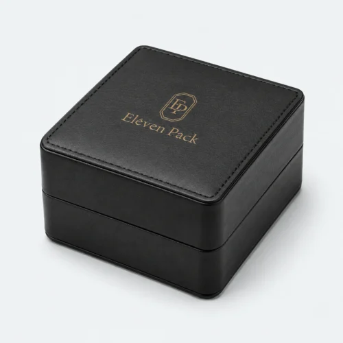Closed black genuine leather watch box with stitched lid and gold logo