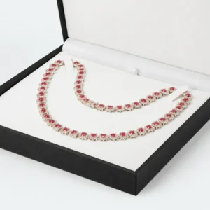 Close-up of white necklace insert and securing tabs in open black box