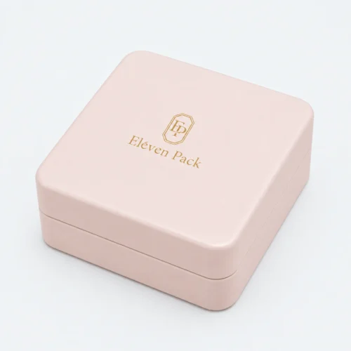 Closed dusty pink leather necklace box with gold Eleven Pack logo