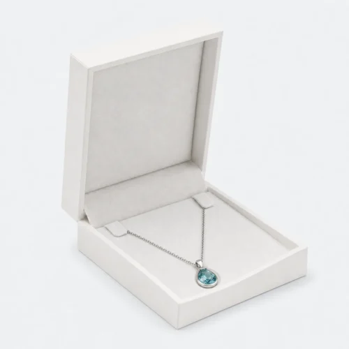 Custom White PU Leather Flip Top Necklace Box Image 01 Main Open - JB-BM-05-P26 Open white PU leather necklace box with pale insert and blue pendant necklace