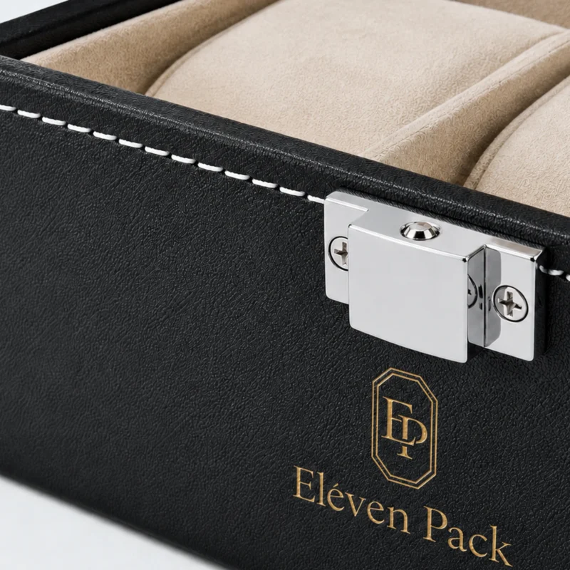 Close-up of centered silver clasp, white stitching and gold logo on black watch box