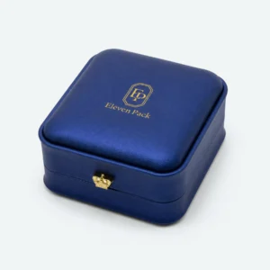 Closed blue PU leather ring box with crown clasp and gold Eleven Pack logo