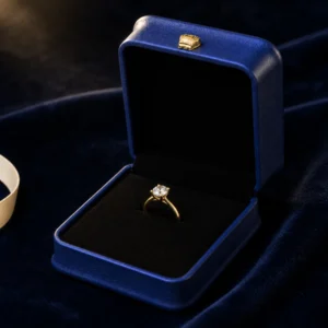 Blue ring presentation box displayed on dark blue velvet