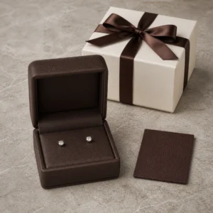 Brown genuine leather earring box with stud earrings and coordinated packaging material samples