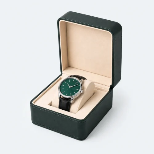 Open green and beige genuine leather watch box with wristwatch displayed inside