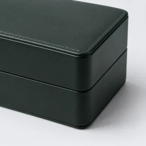 Green and beige genuine leather watch box showing the stitched lid detail