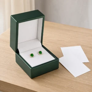 Dark Green PU Leather Earring Box - Packaging System Scene Dark green PU leather earring box with green stud earrings and coordinated packaging material samples